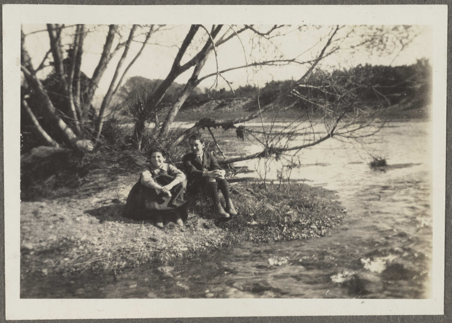 Charles and Lesley Brasch sitting beside a river