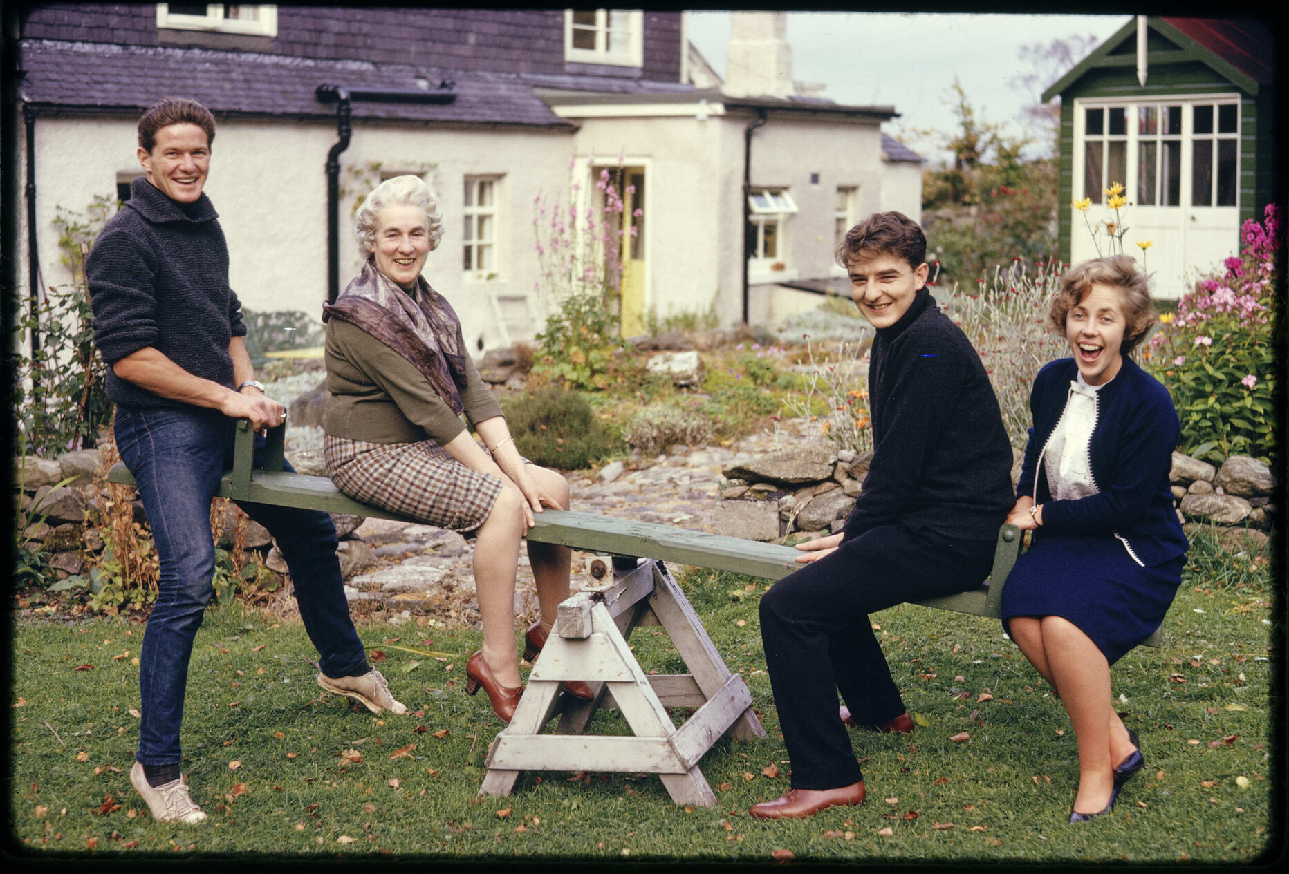 Christopher [?], Mrs Mackintosh, Julian, and Alison, on a see-saw