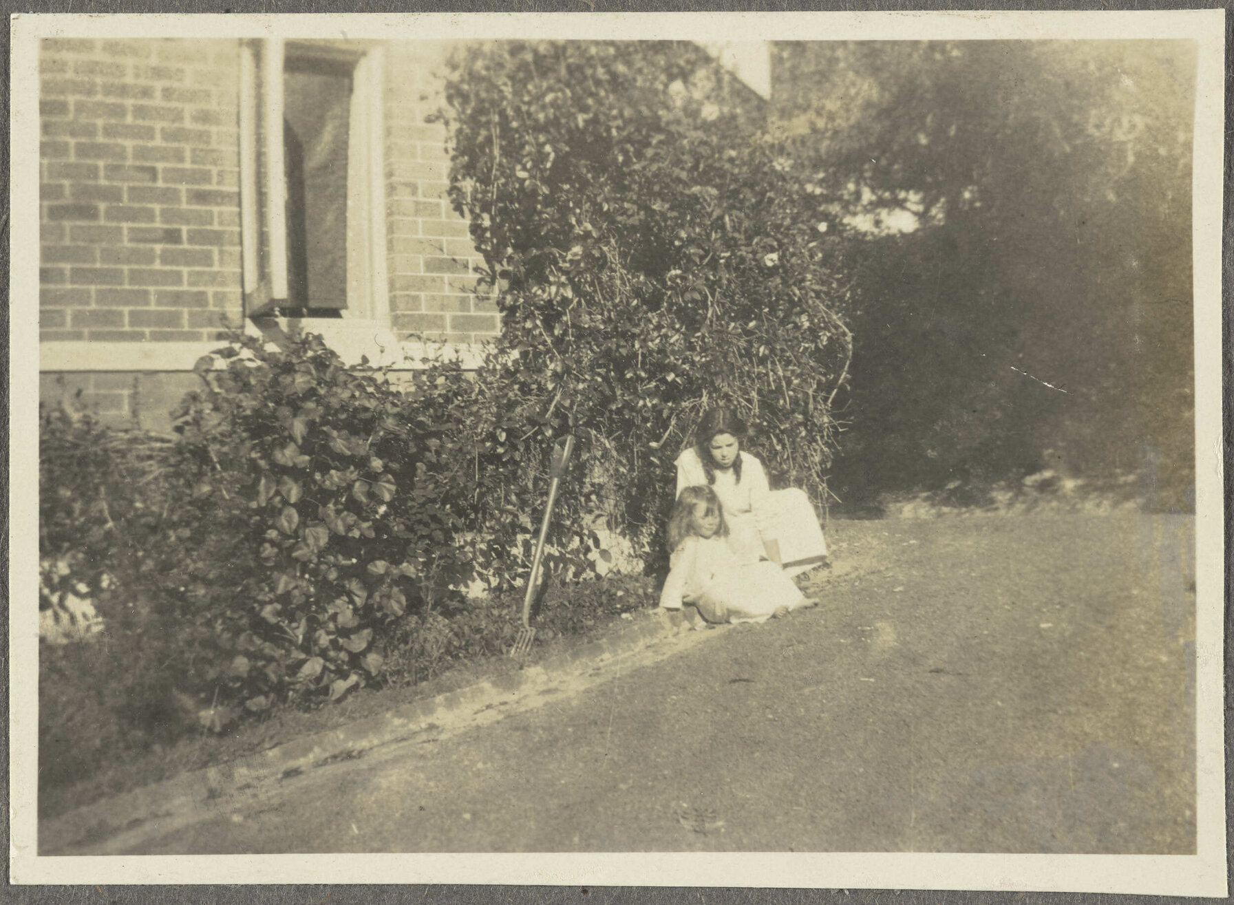 Lesley Brasch and [Elespie Forsyth] sitting by garden
