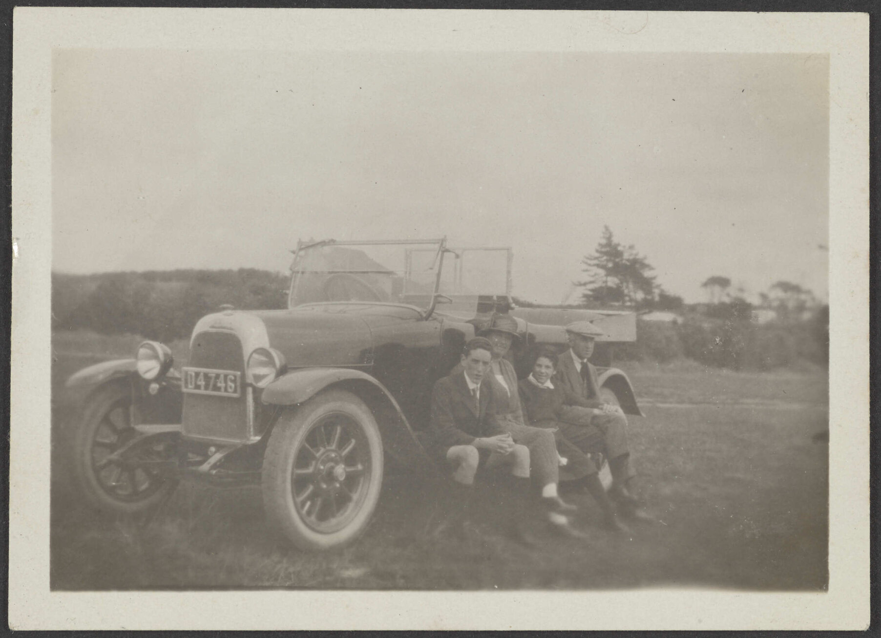 Charles, Lesley and Henry Brasch and unidentified women sitting on a car