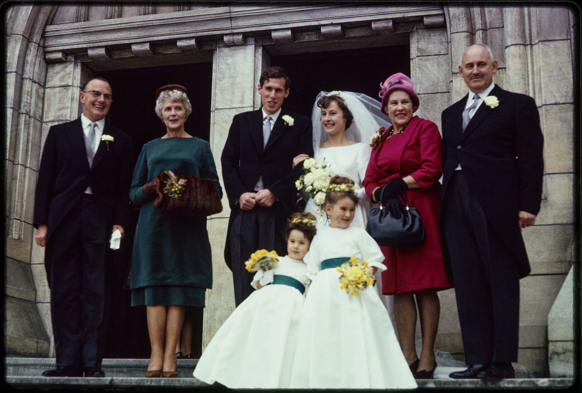 Jennifer and Barry Scott on their wedding day, with their parents, and flower girls