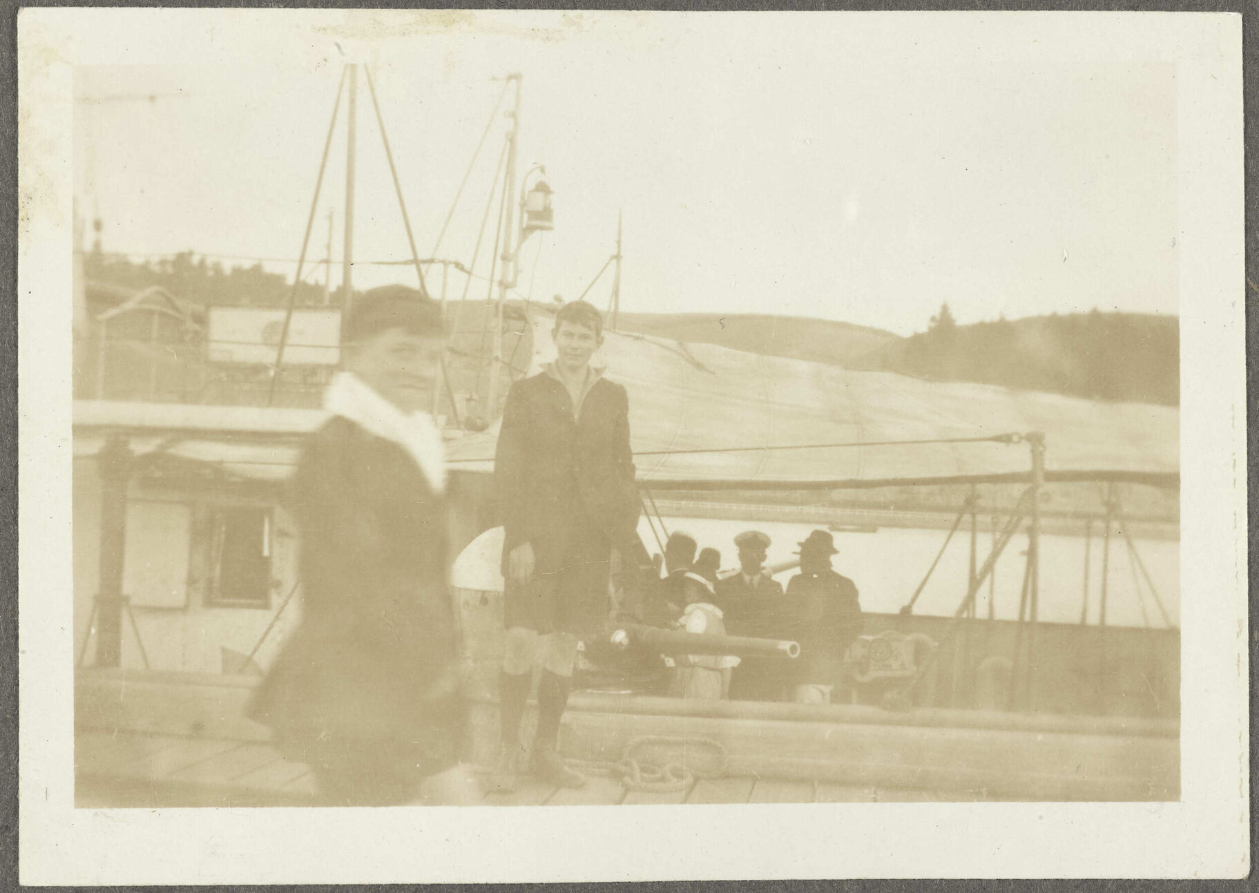 Two boys in front of ship