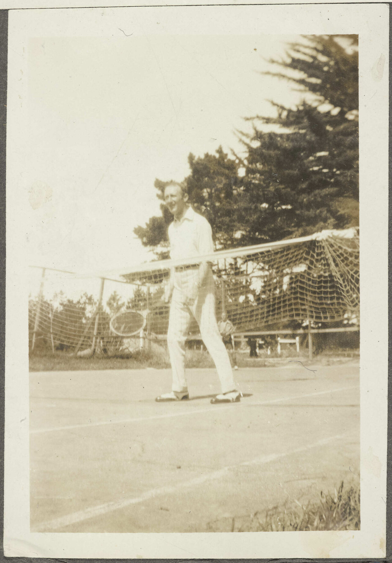 Man on tennis court holding racket