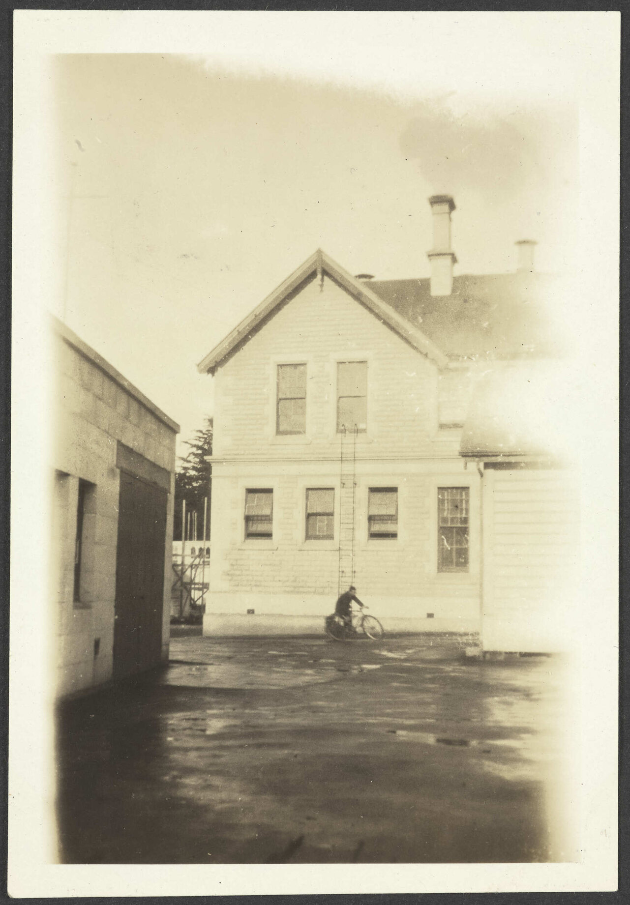 Boy on bicycle in front of Waitaki Boys' High School building