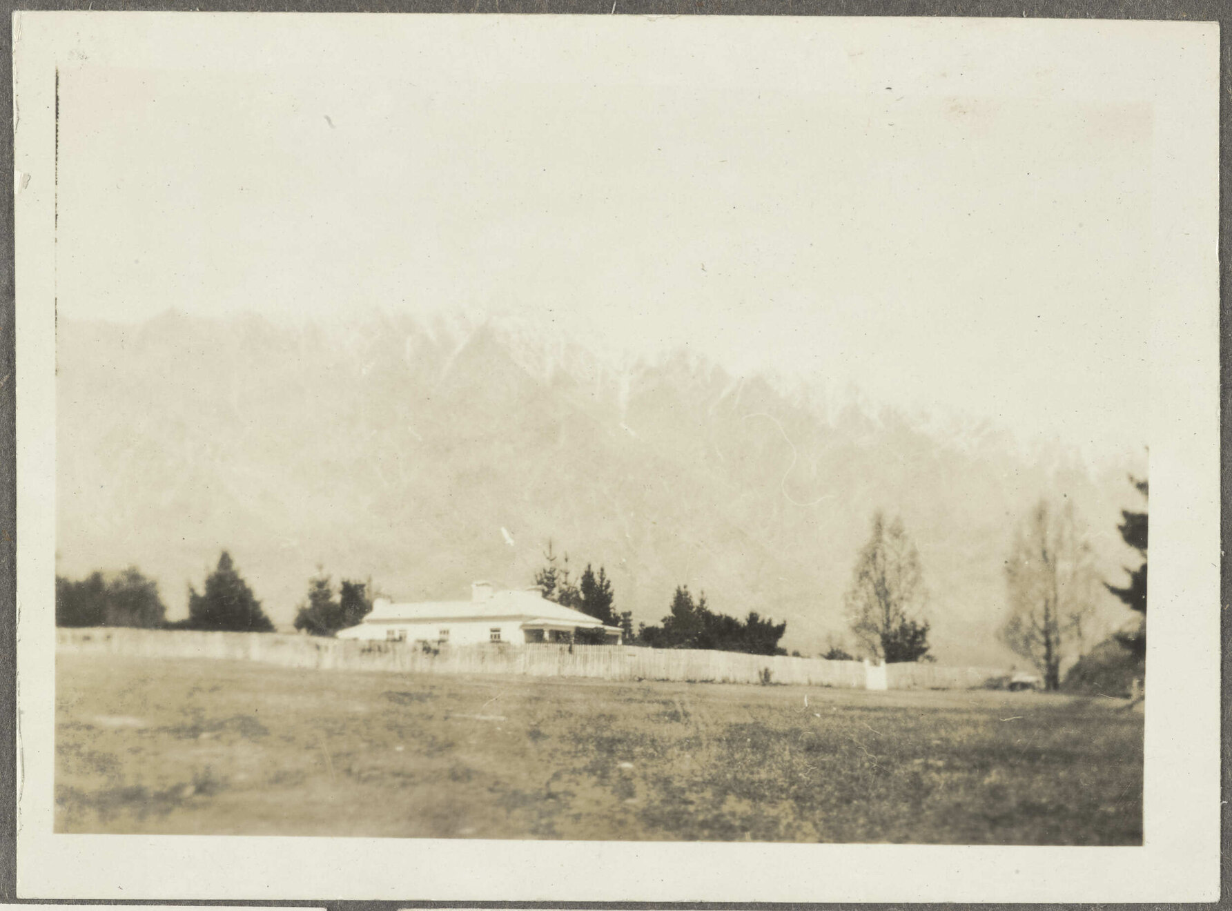 House with snow-capped mountains in background