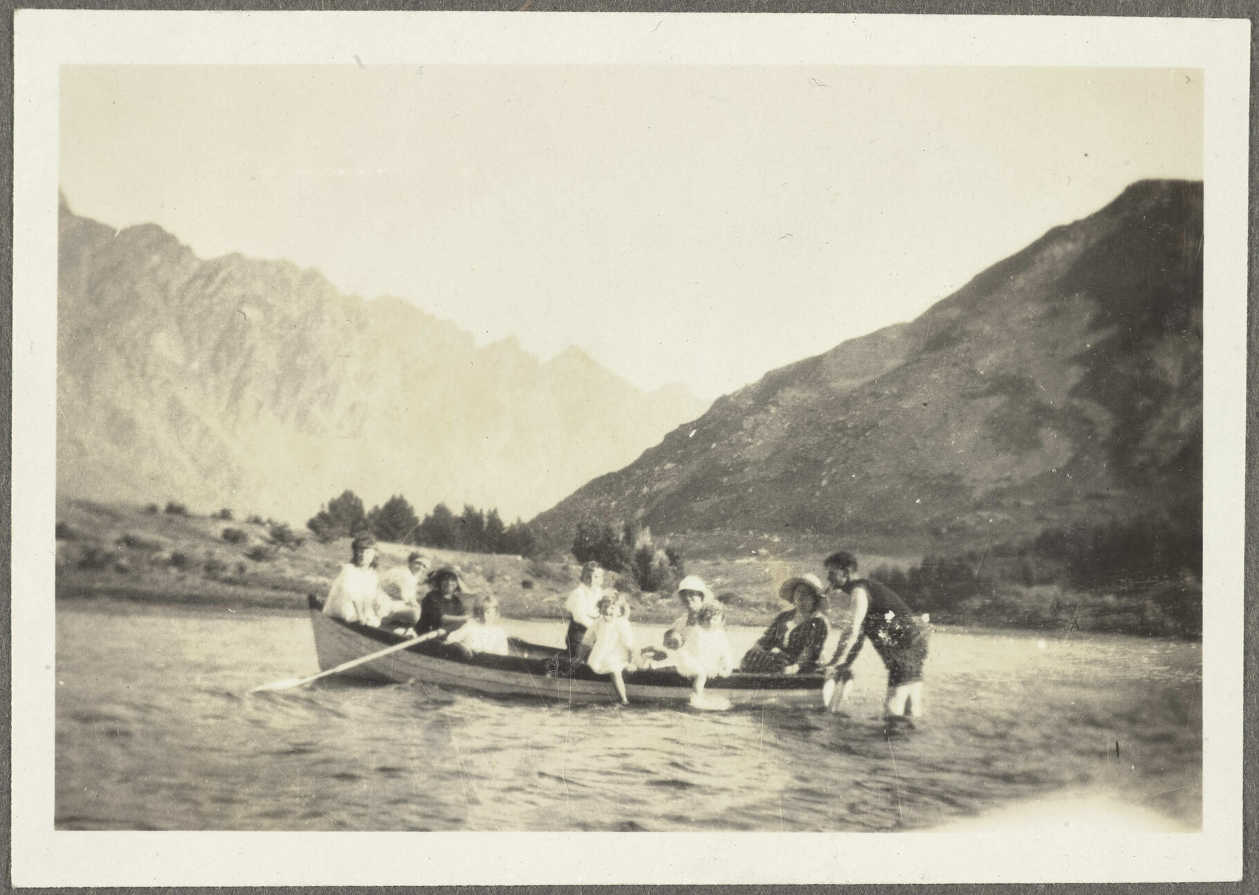 Ten unidentified people in a row boat