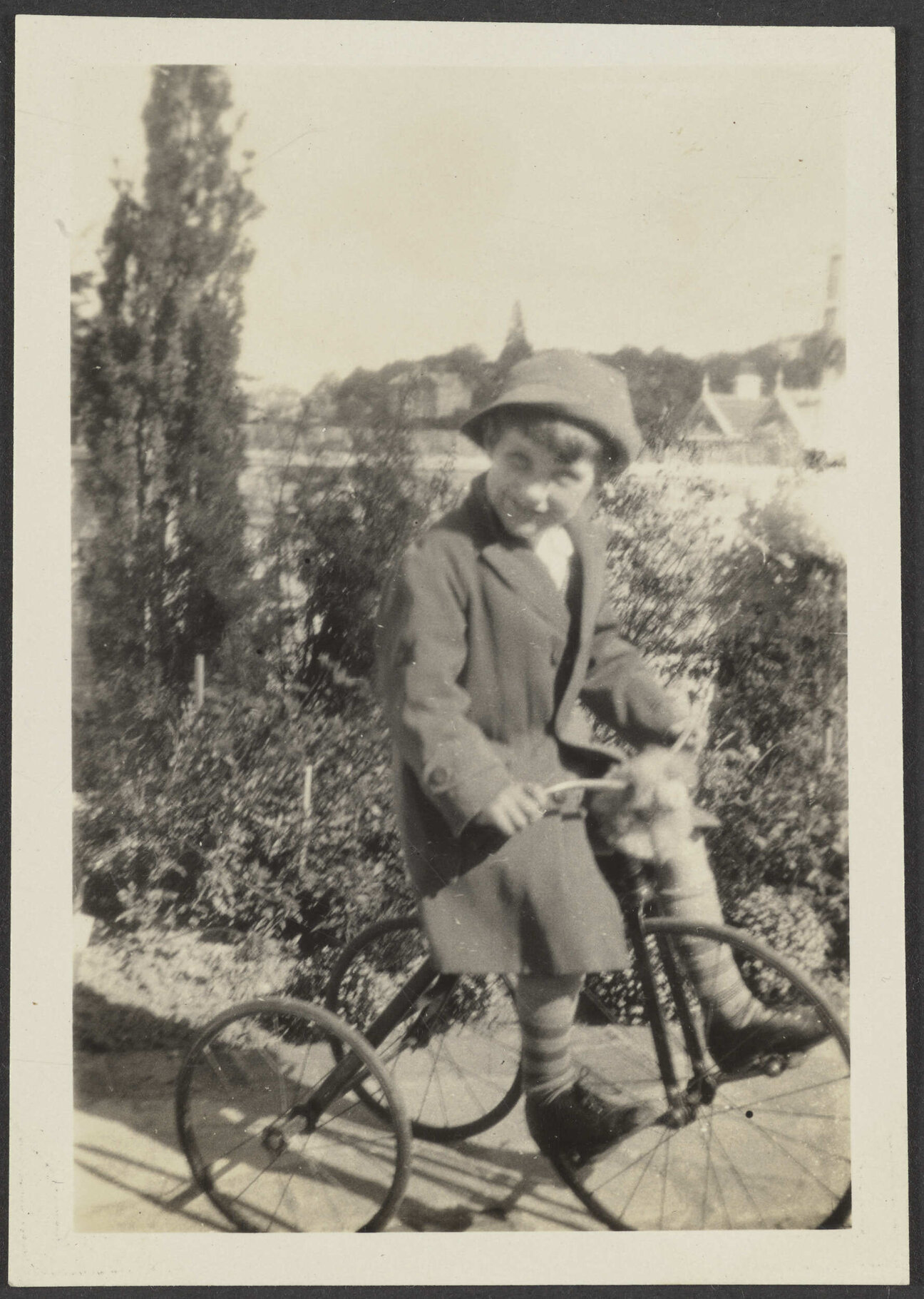 Unidentified child riding a tricycle
