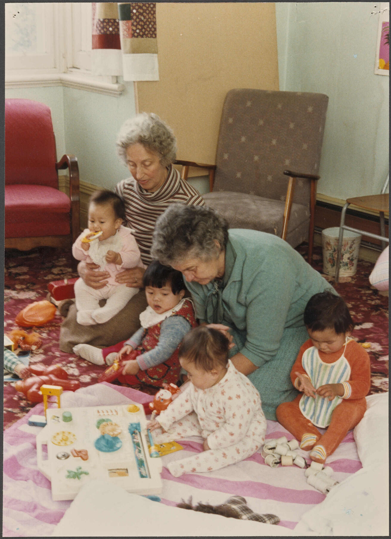 Barbara and Eva, volunteer childcare workers, with children at the Otago Polytechnic Adult Learning Centre