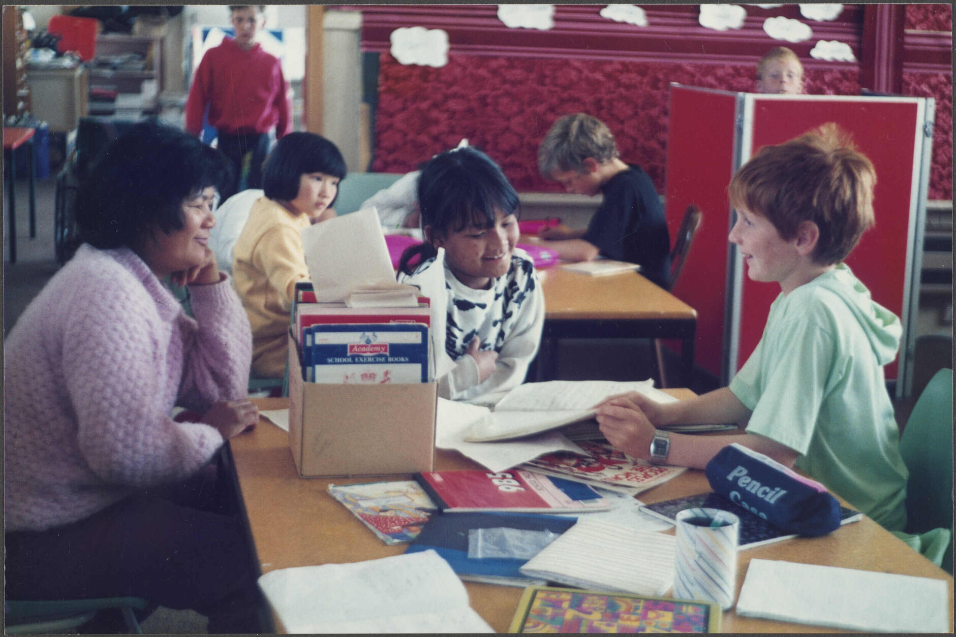Adult English language teacher visiting primary school children