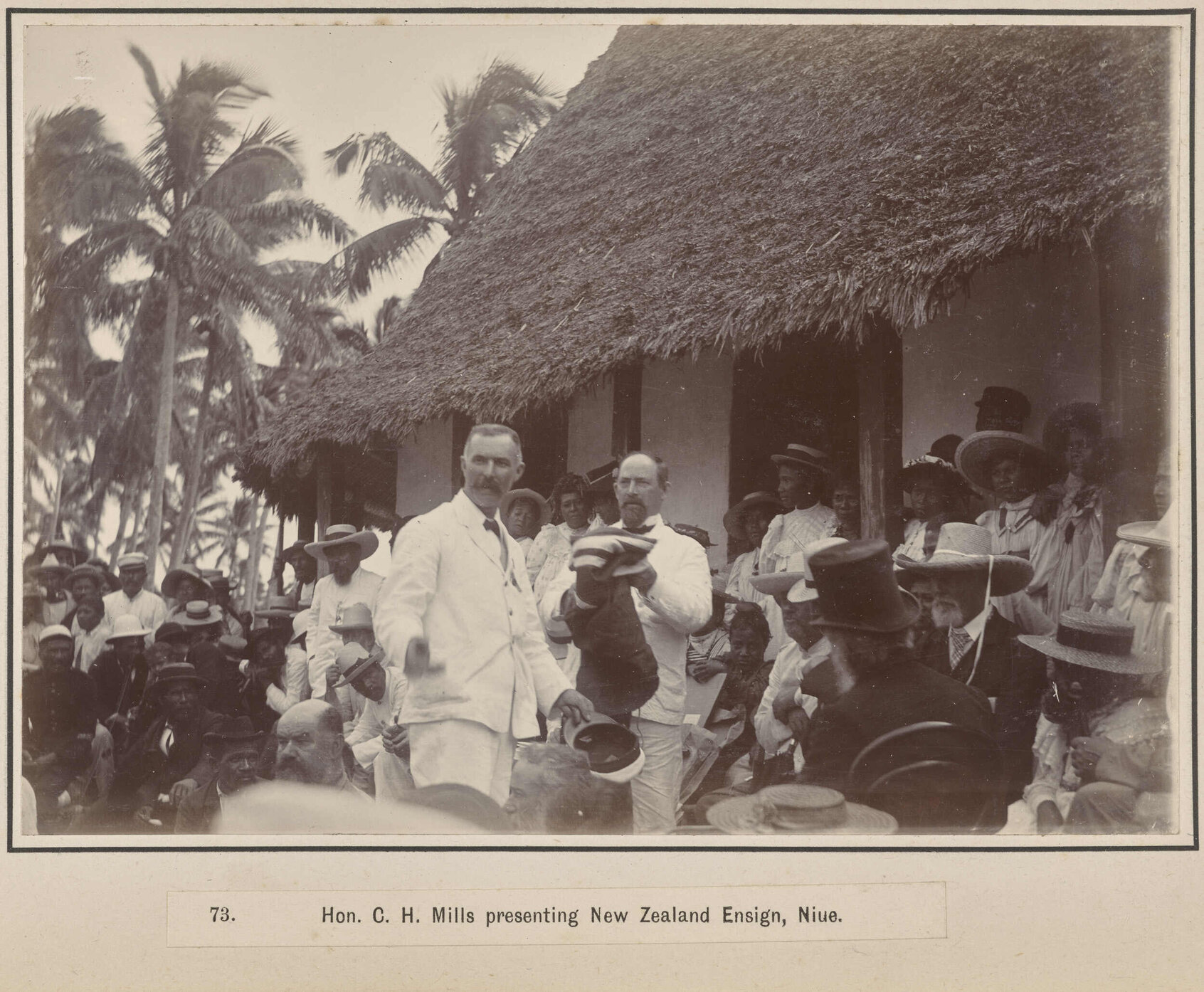 Hon. C.H. Mills presenting New Zealand Ensign, Niue