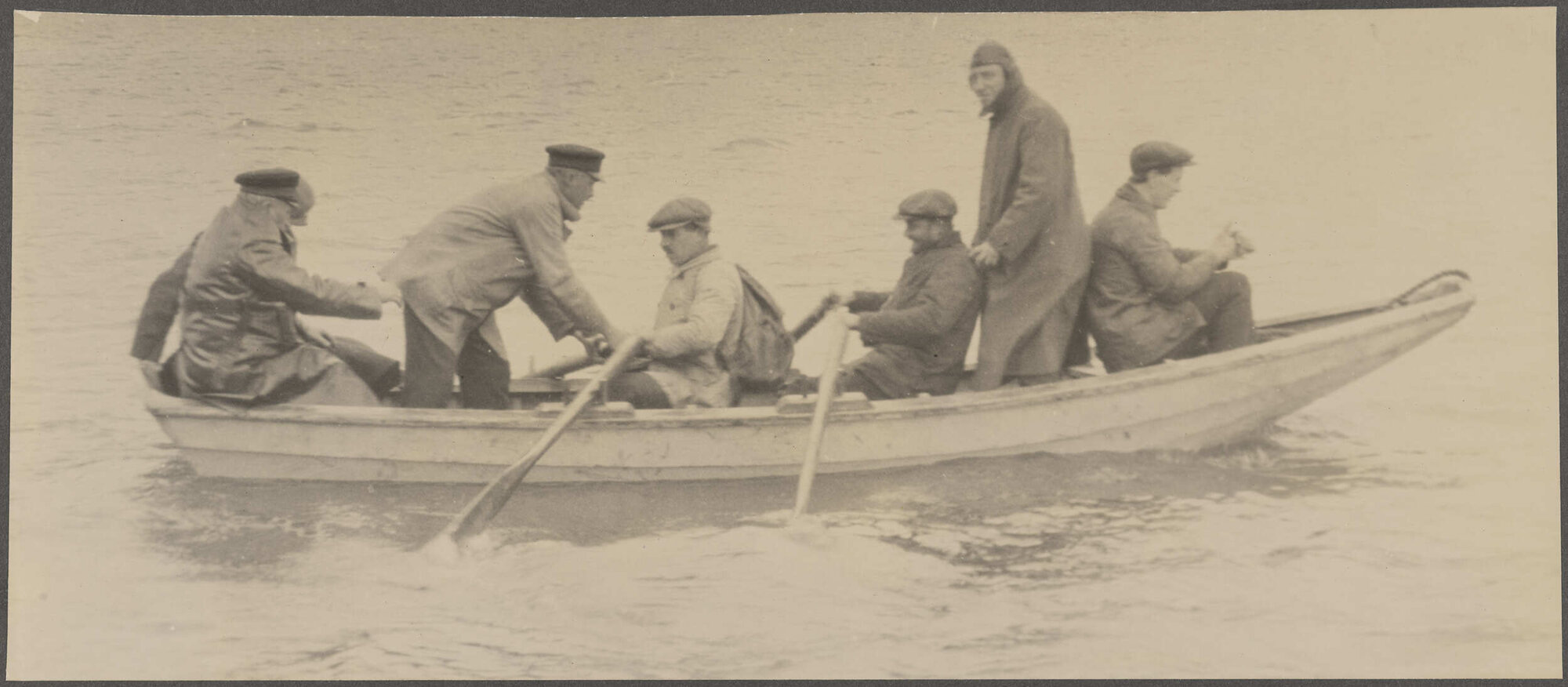 Crew members on board a small rowboat