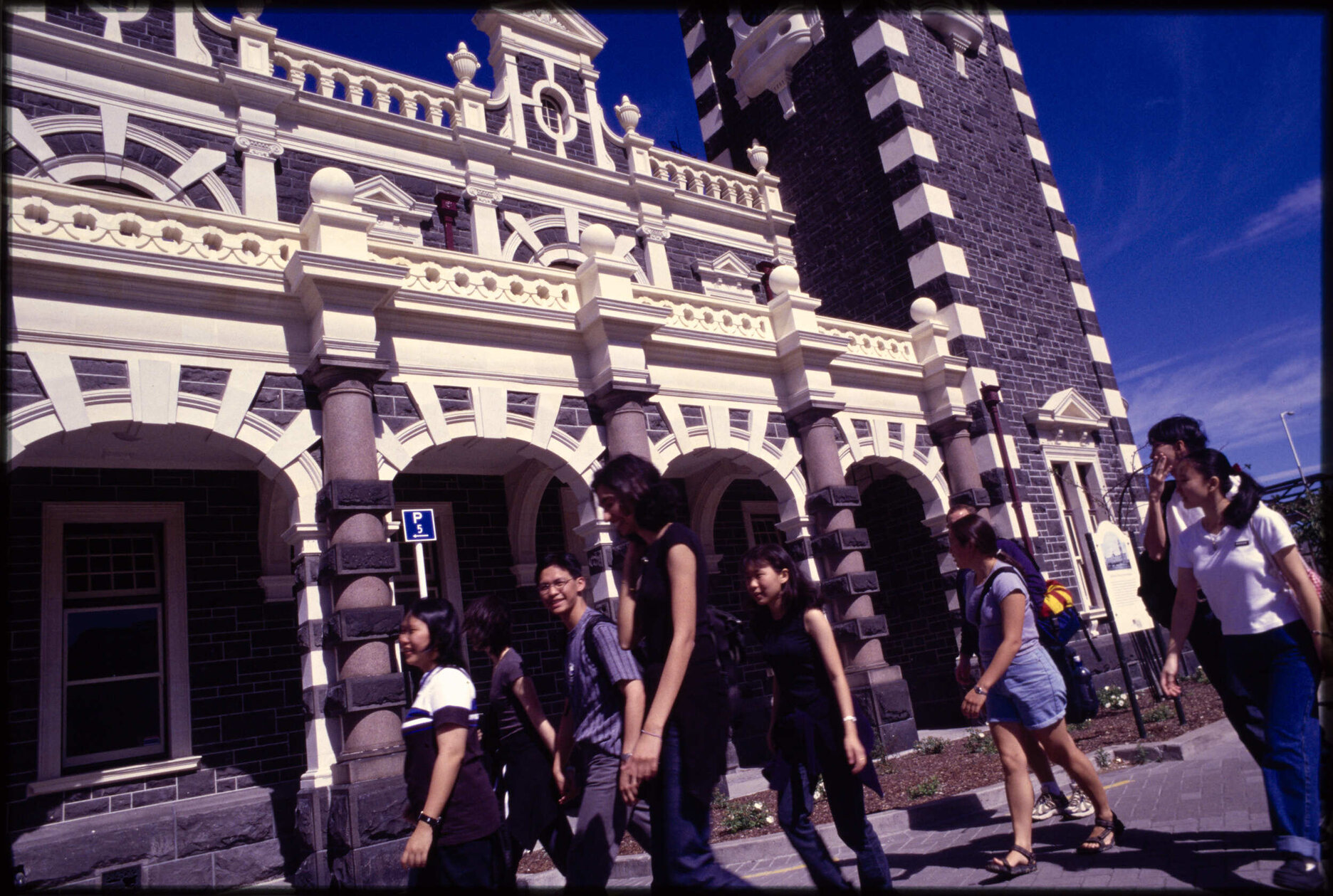 People walking in front of Dunedin Railway Station