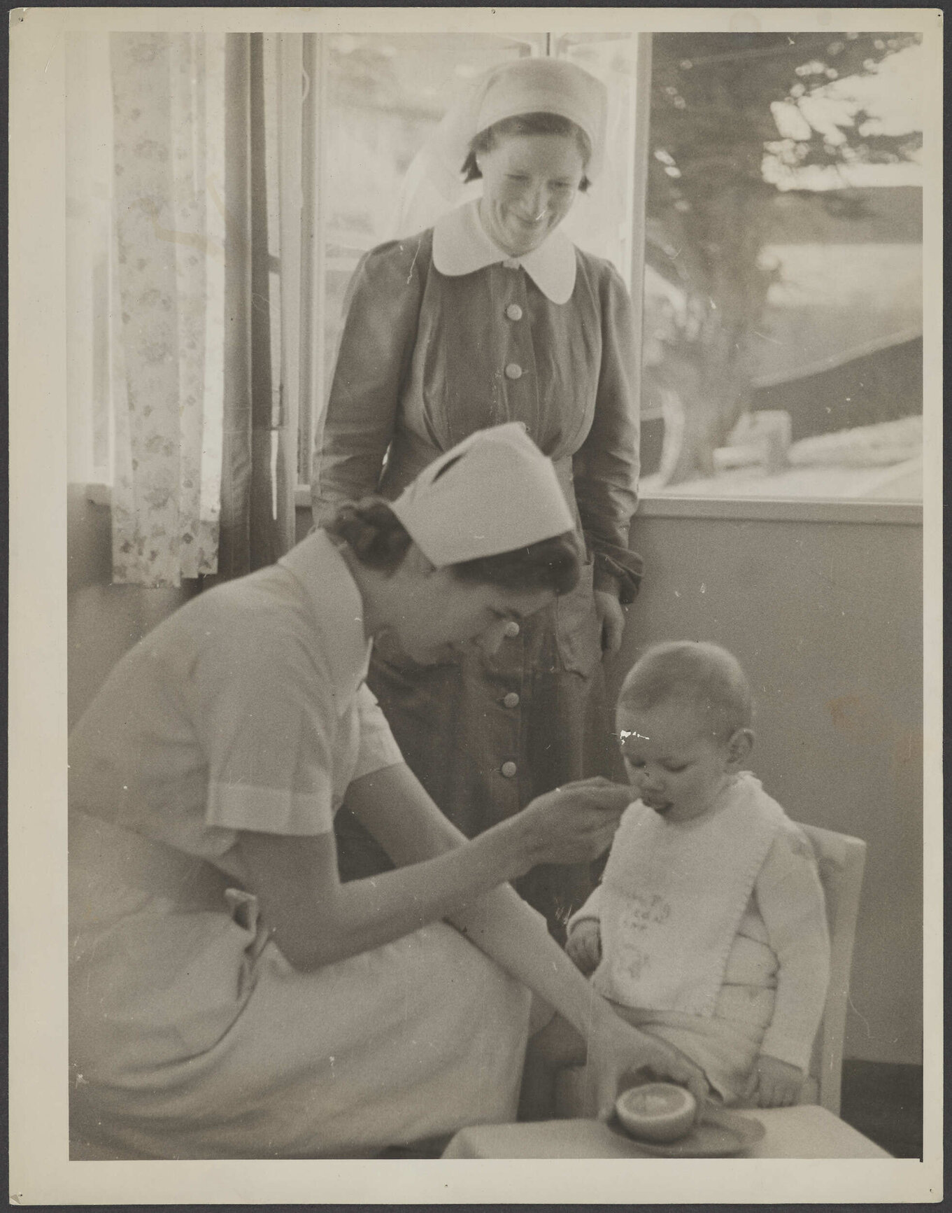 Nurse feeding baby