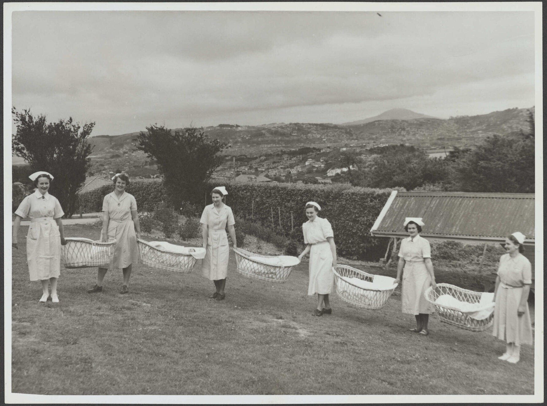 Nurses holding bassinets