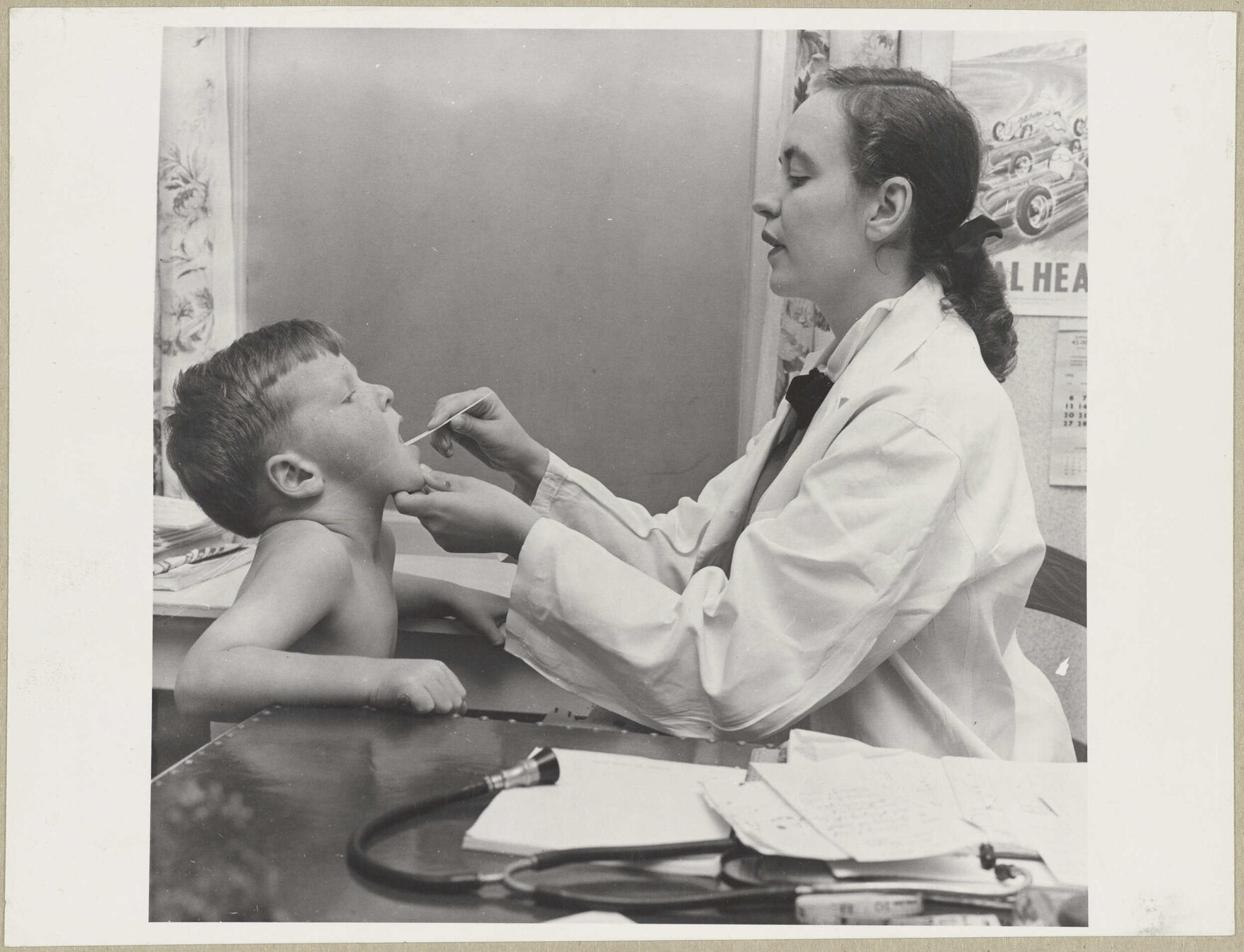 Doctor inspecting child's mouth