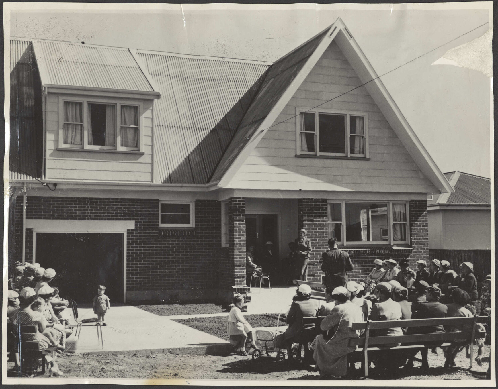 Crowd seated outside building