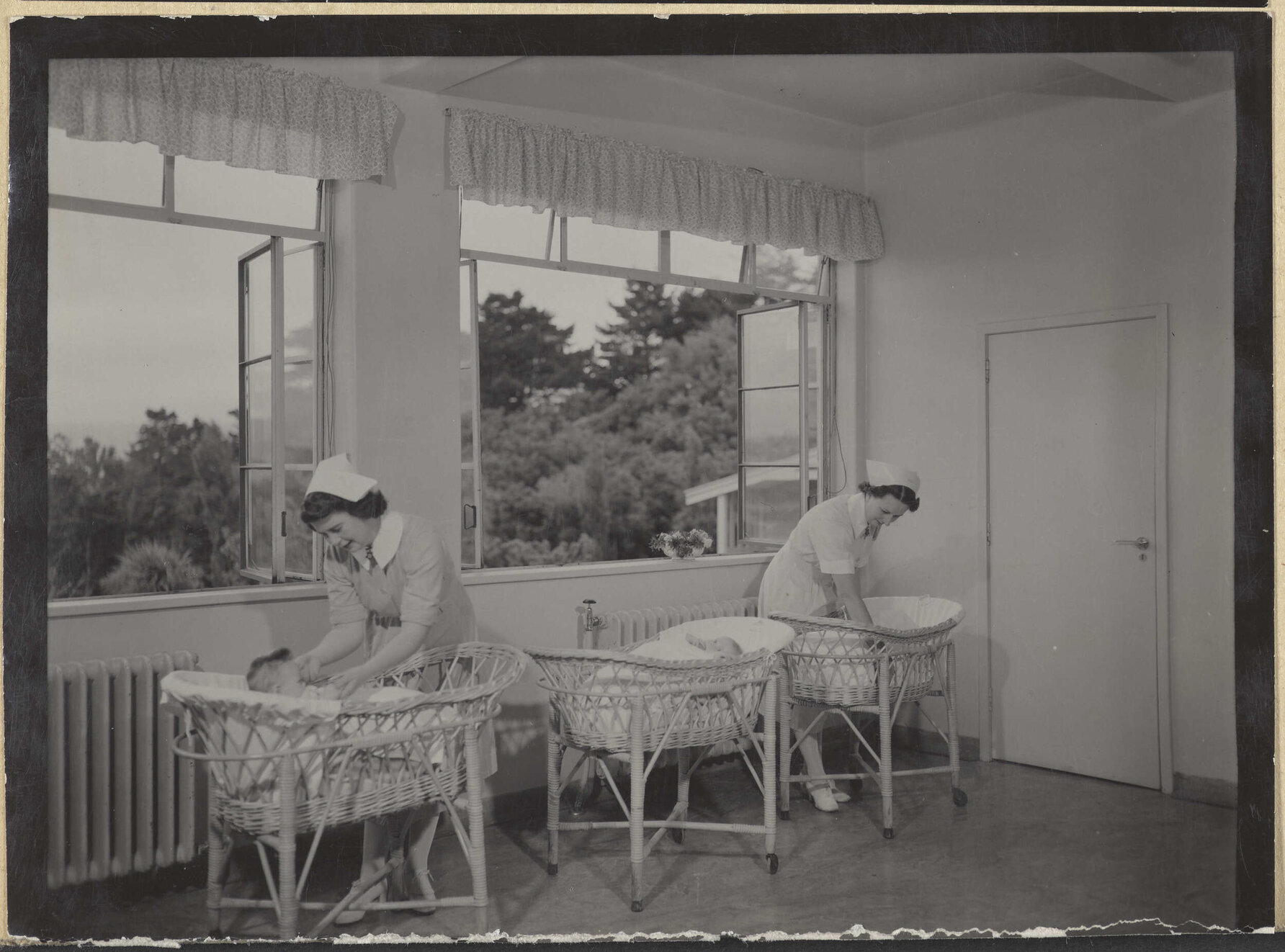 Nurses with babies in bassinets