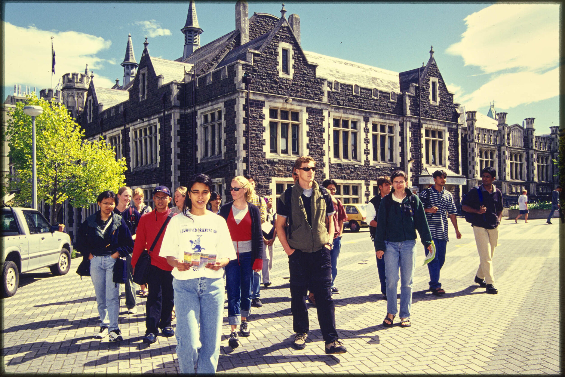 Students walking on campus, with Allen Hall in background