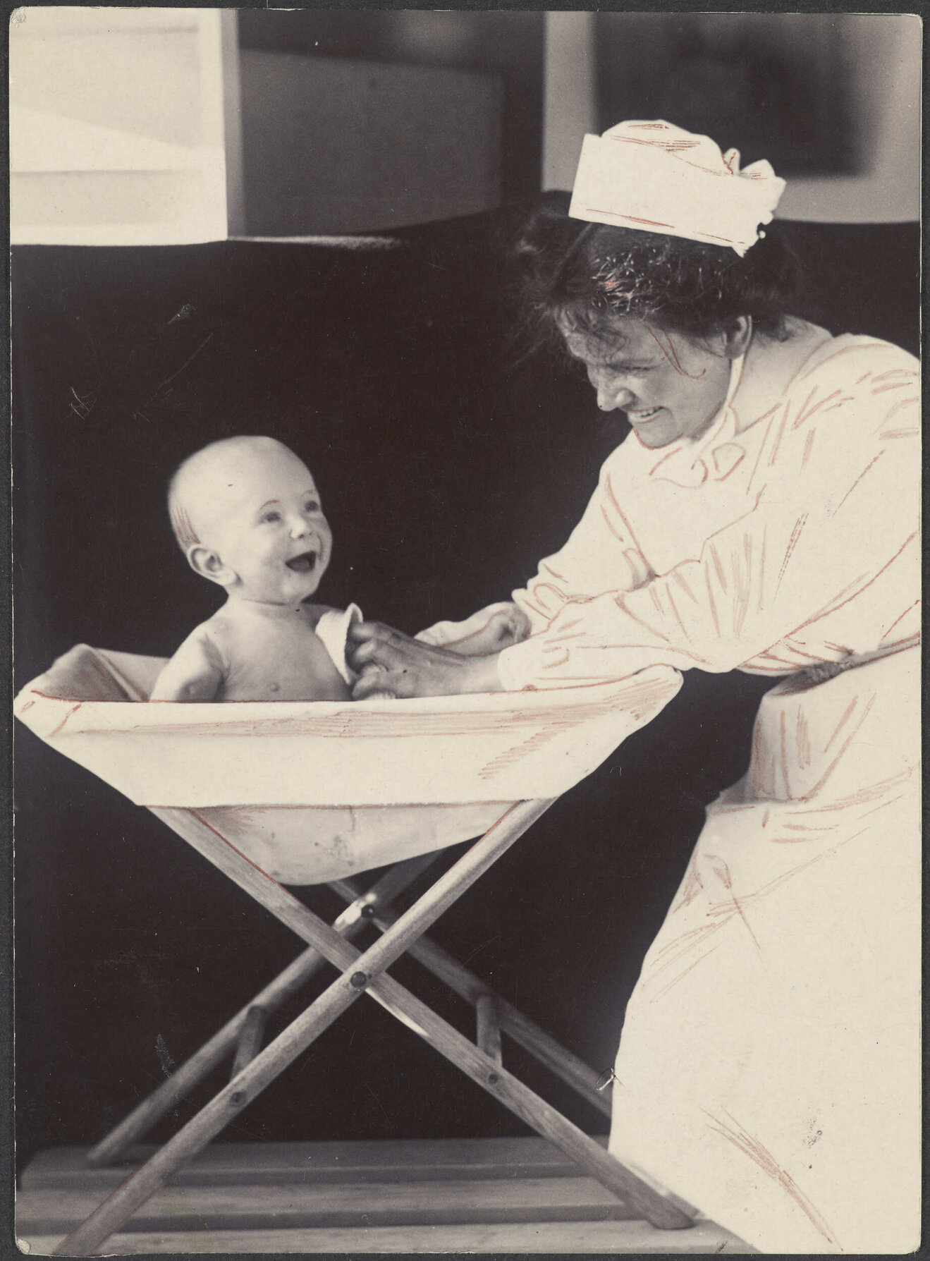 Nurse bathing a baby