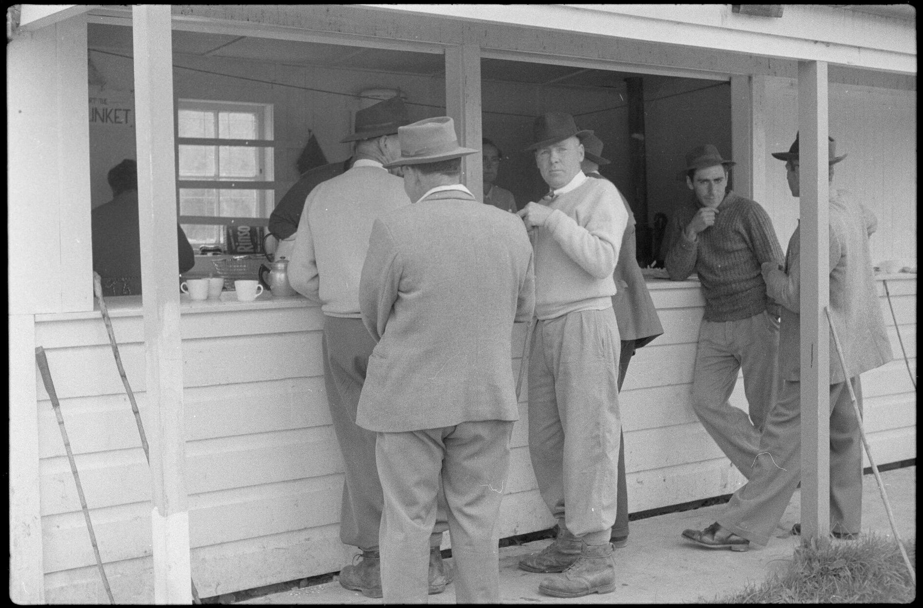 Men standing outside a canteen