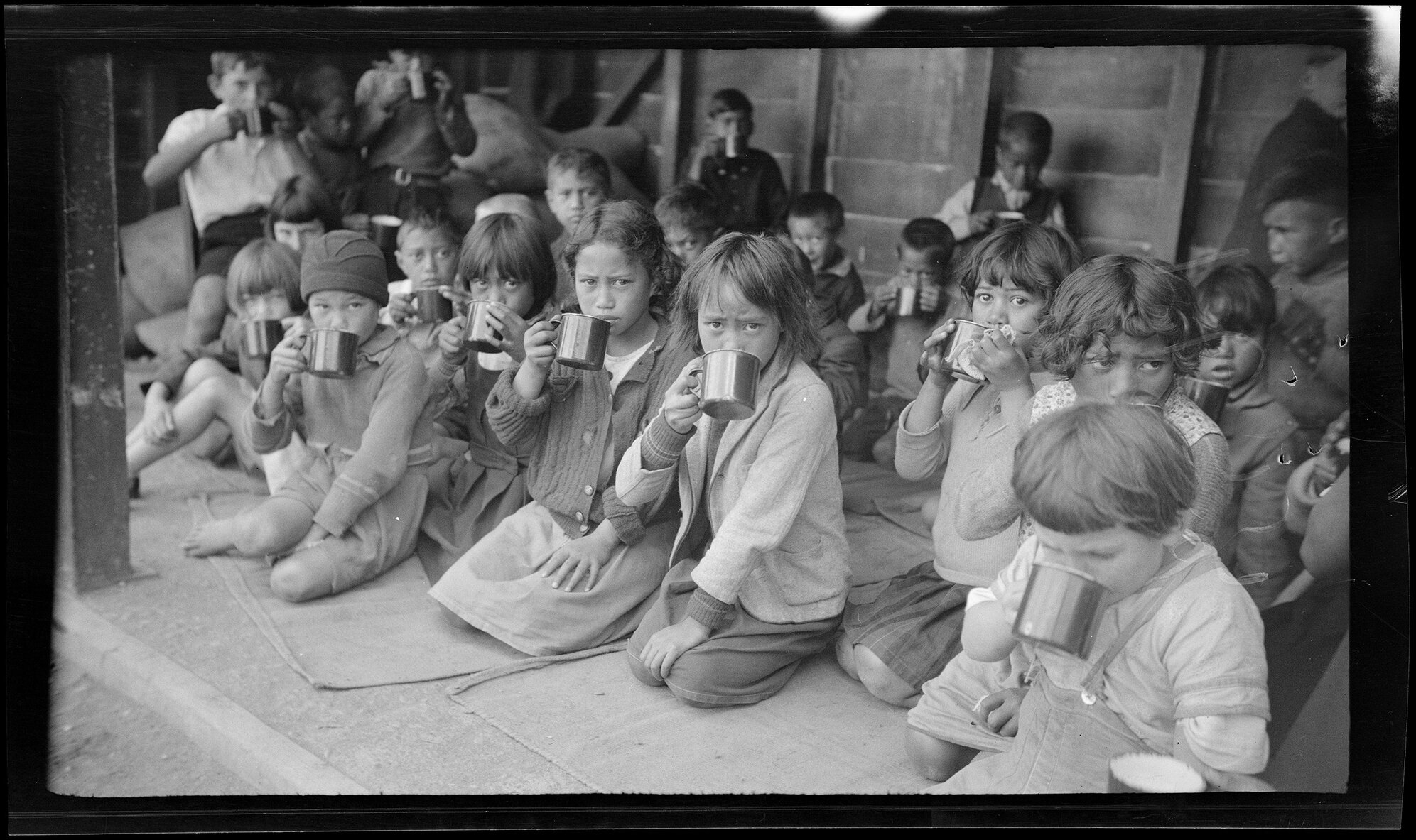 Children drinking from metal cups