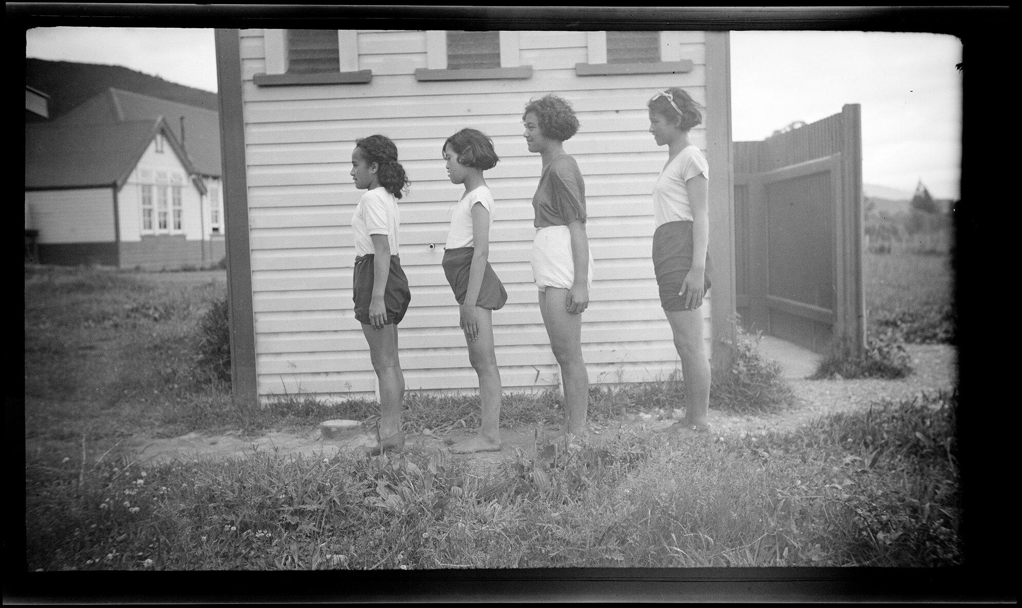 Four girls standing side on