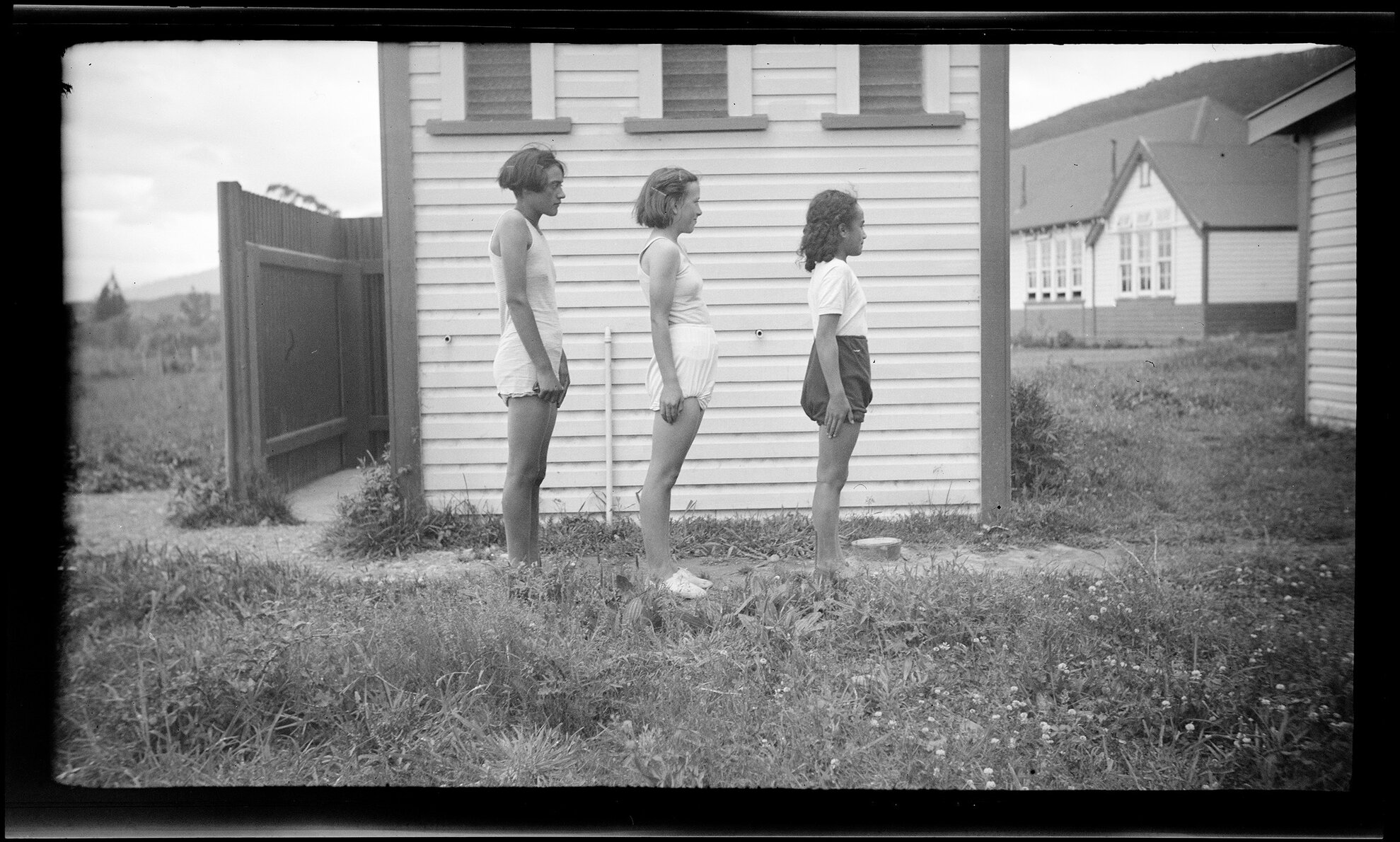 Three girls standing side on