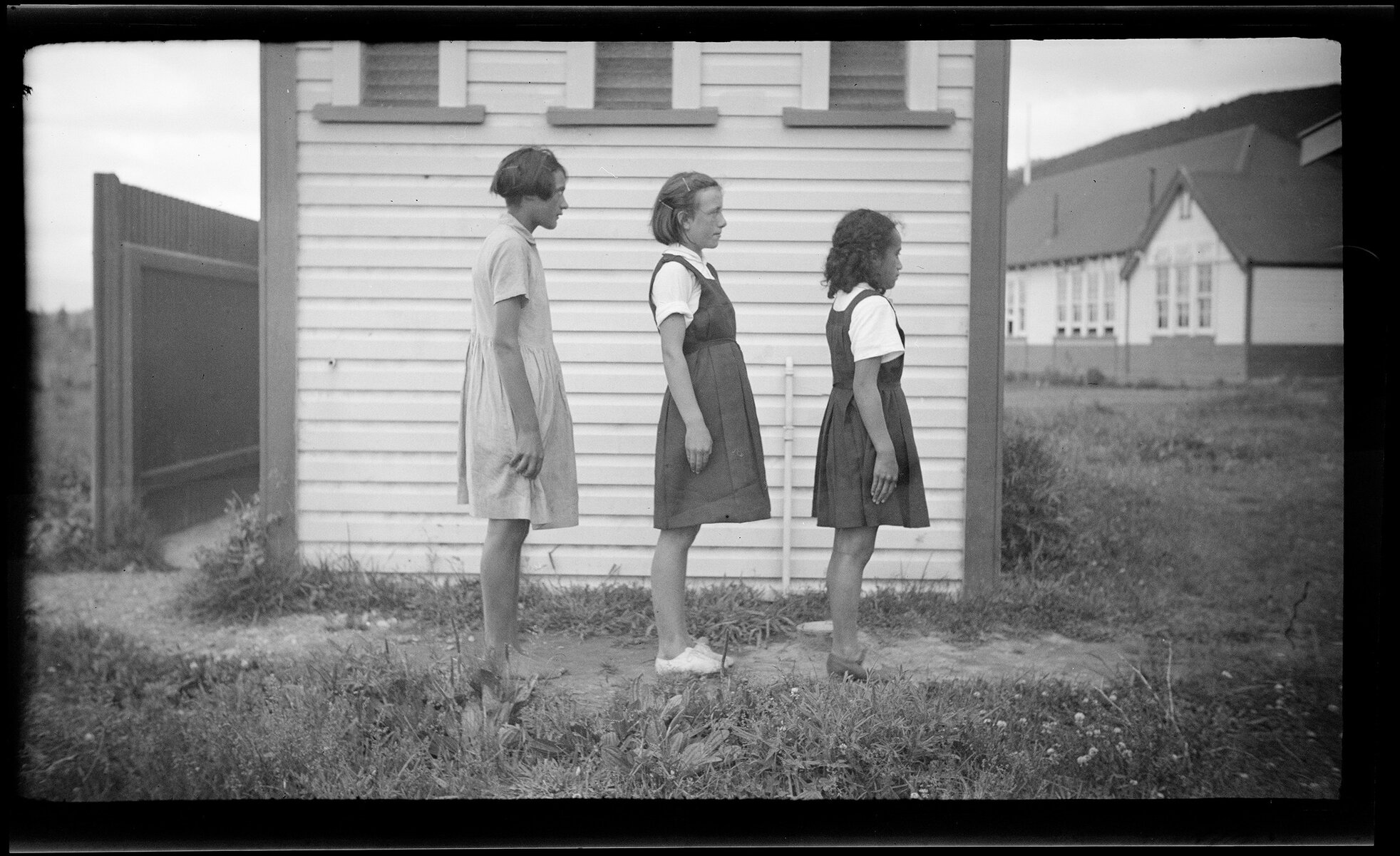 Three girls standing side on
