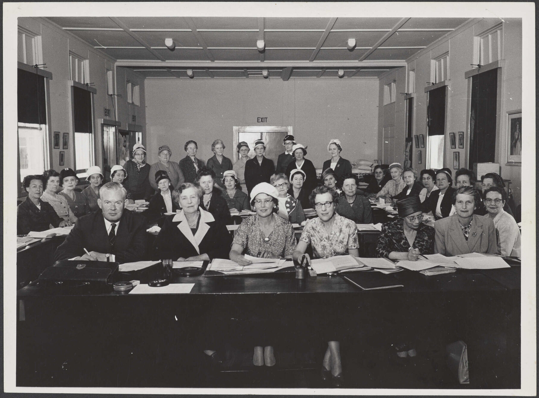 Group of people sitting at desks in a meeting room
