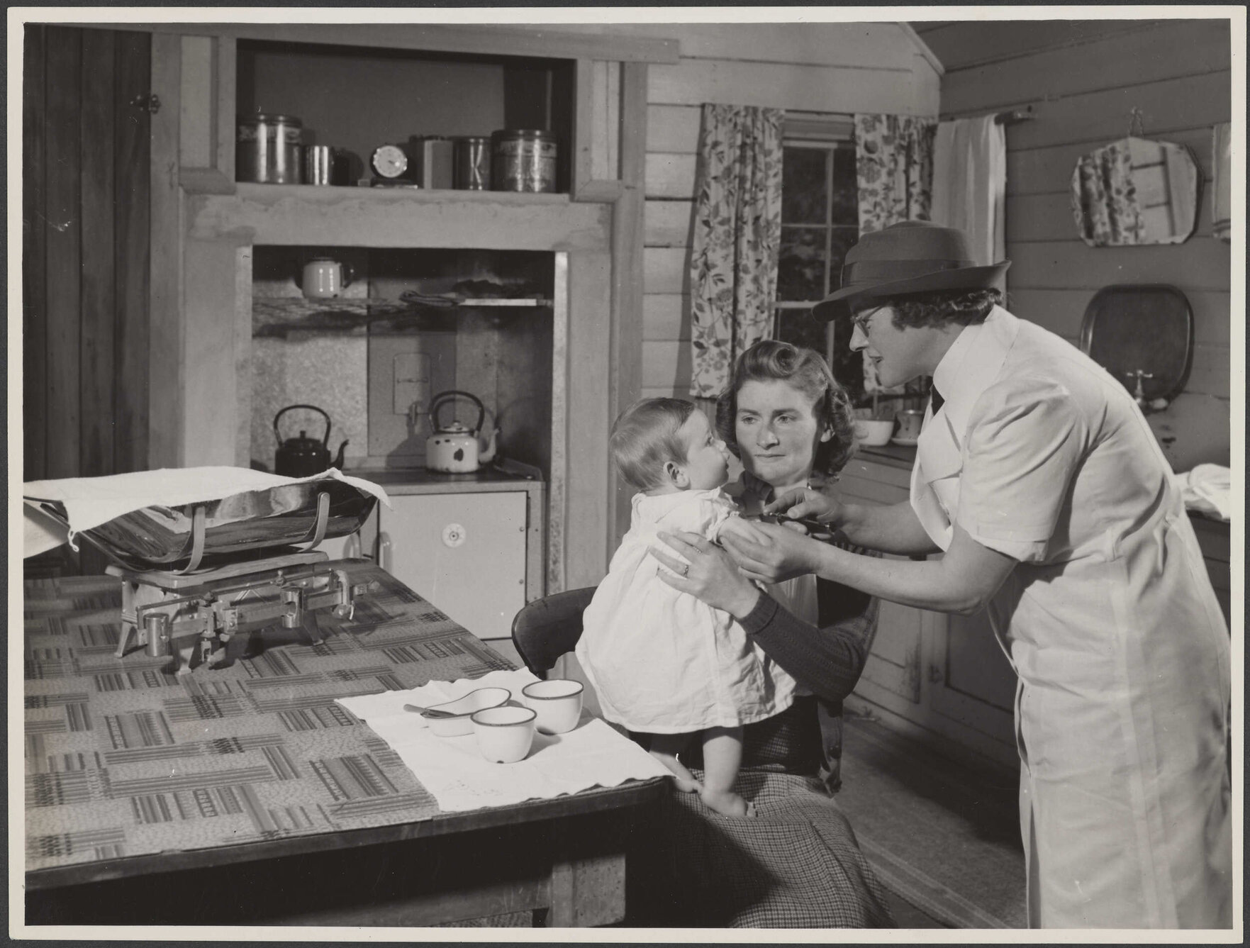 'Baby receiving immunization injection in the home'