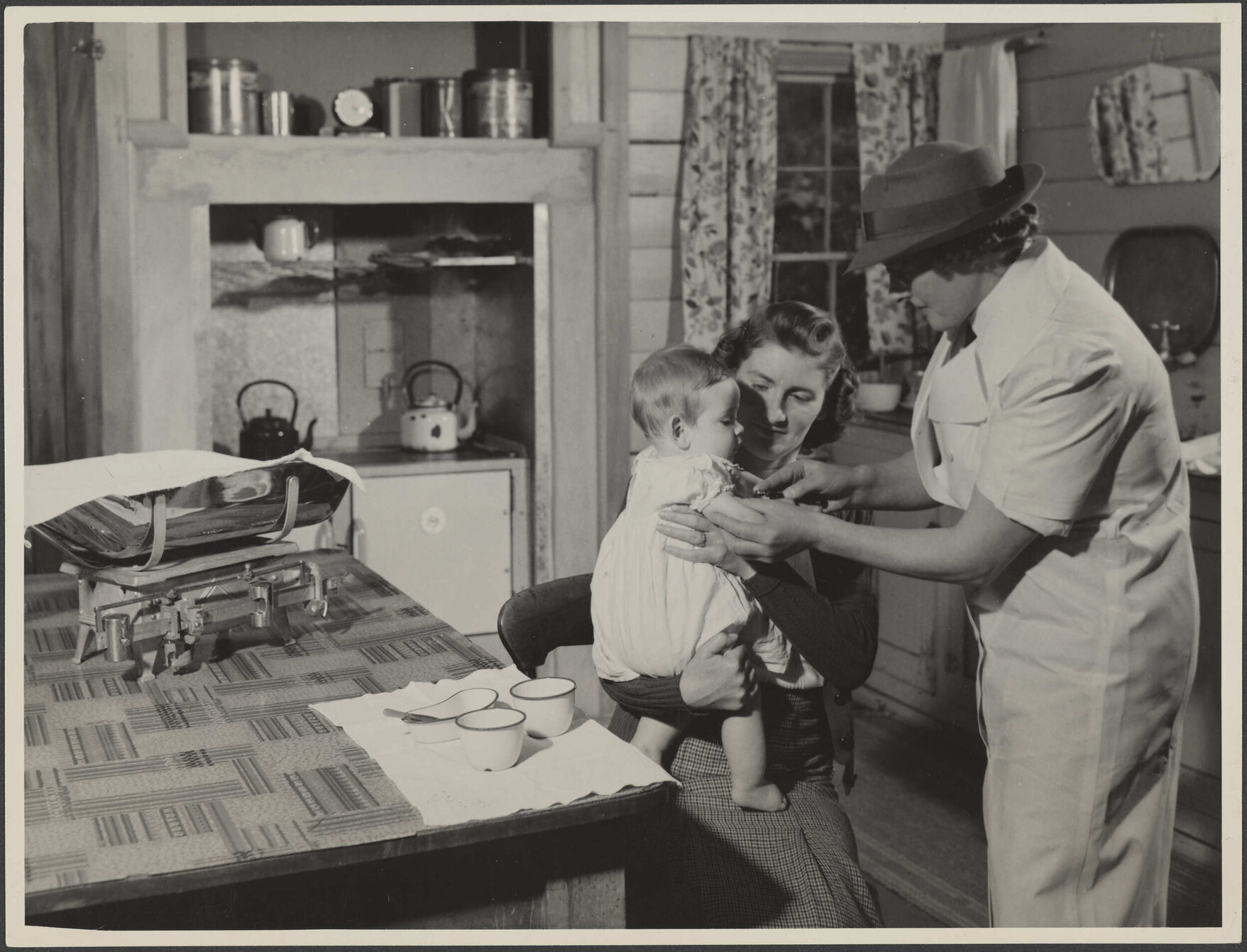 'Baby receiving immunization injection in the home'