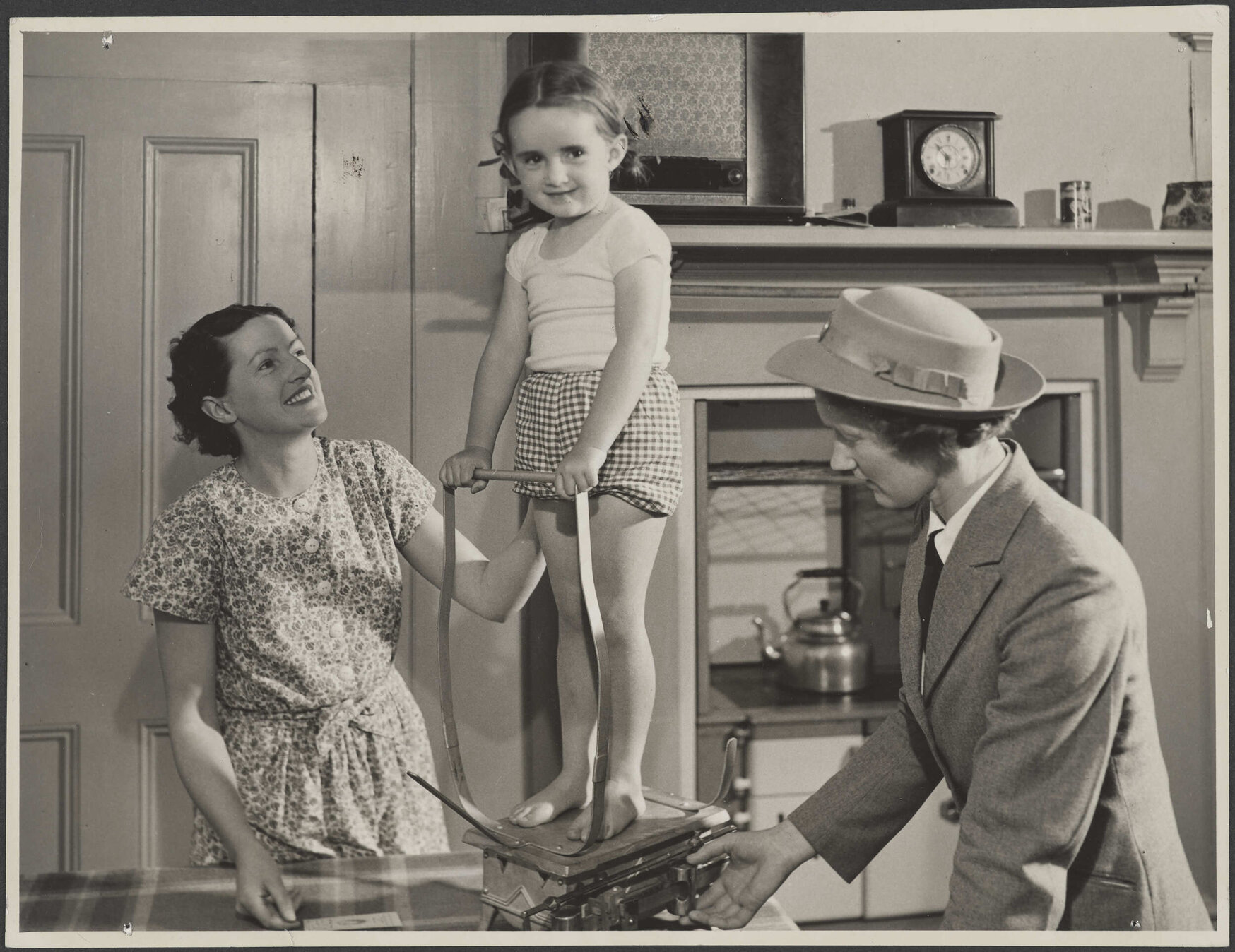 A nurse 'Weighing the Pre School child in the home'