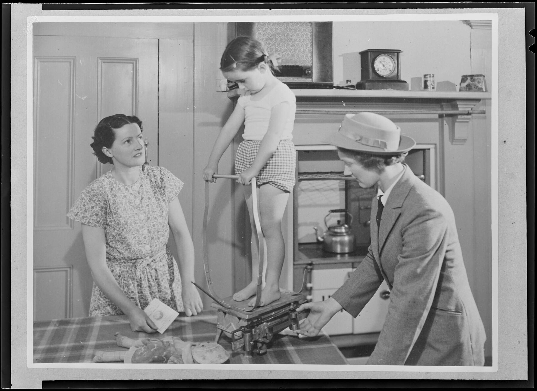 A nurse 'Weighing the Pre School child in the home'