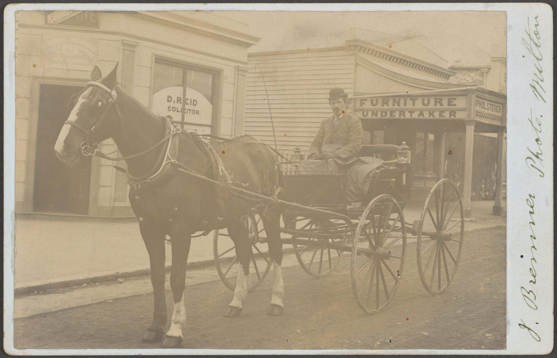 James Skinner in a buggy on the street in Milton
