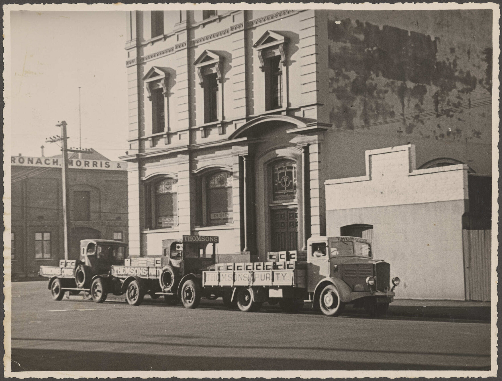 Three delivery trucks outside Thomsons premises