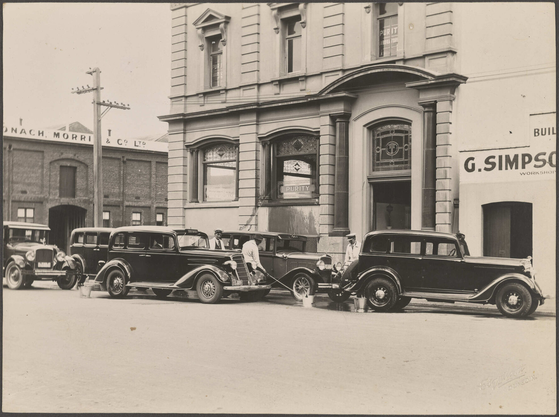 Taxis being washed outside Thomsons premises