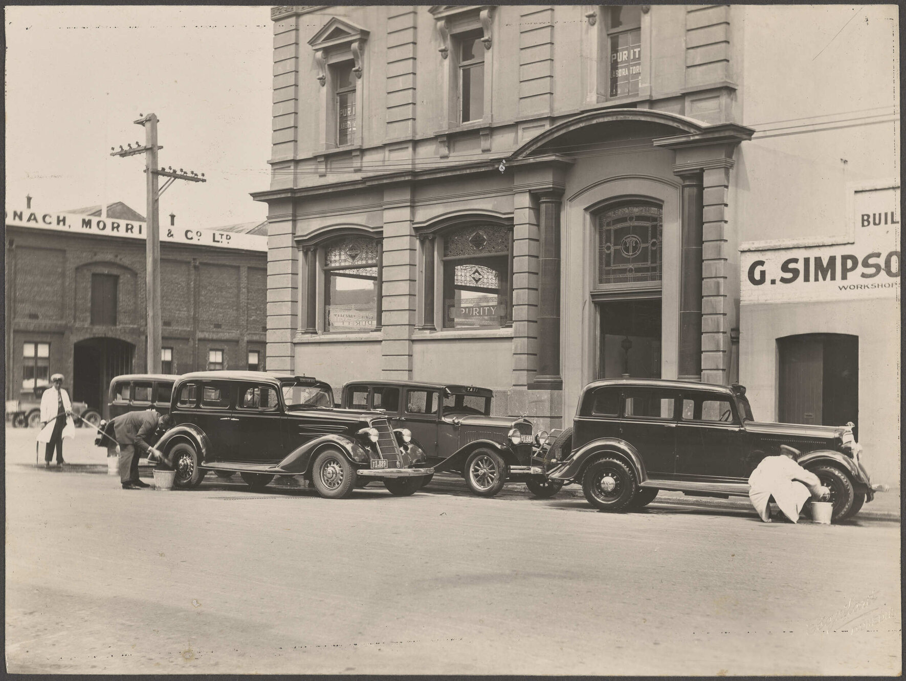 Taxis being washed outside Thomsons premises