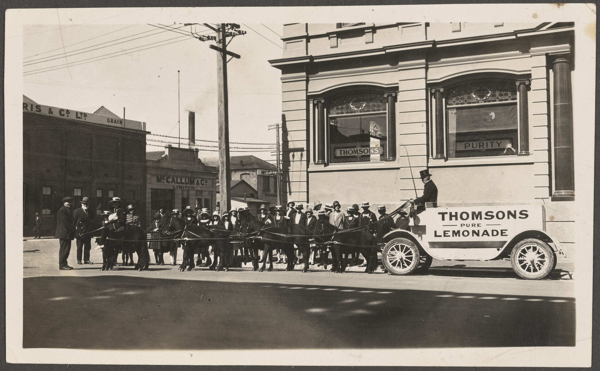 People gathered by Thomsons Lemonade pony-drawn wagon at the corner of Police and Crawford streets