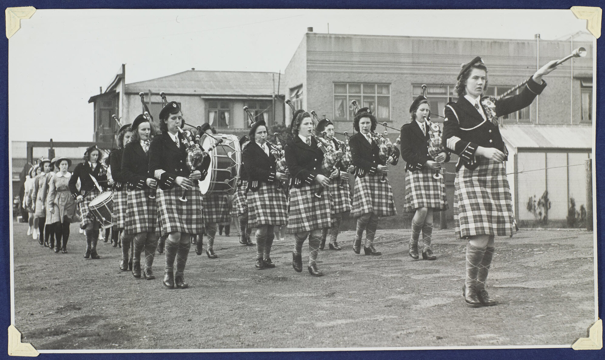 The Dunedin Ladies' Scottish Pipe Band  marching into the Caledonian Ground