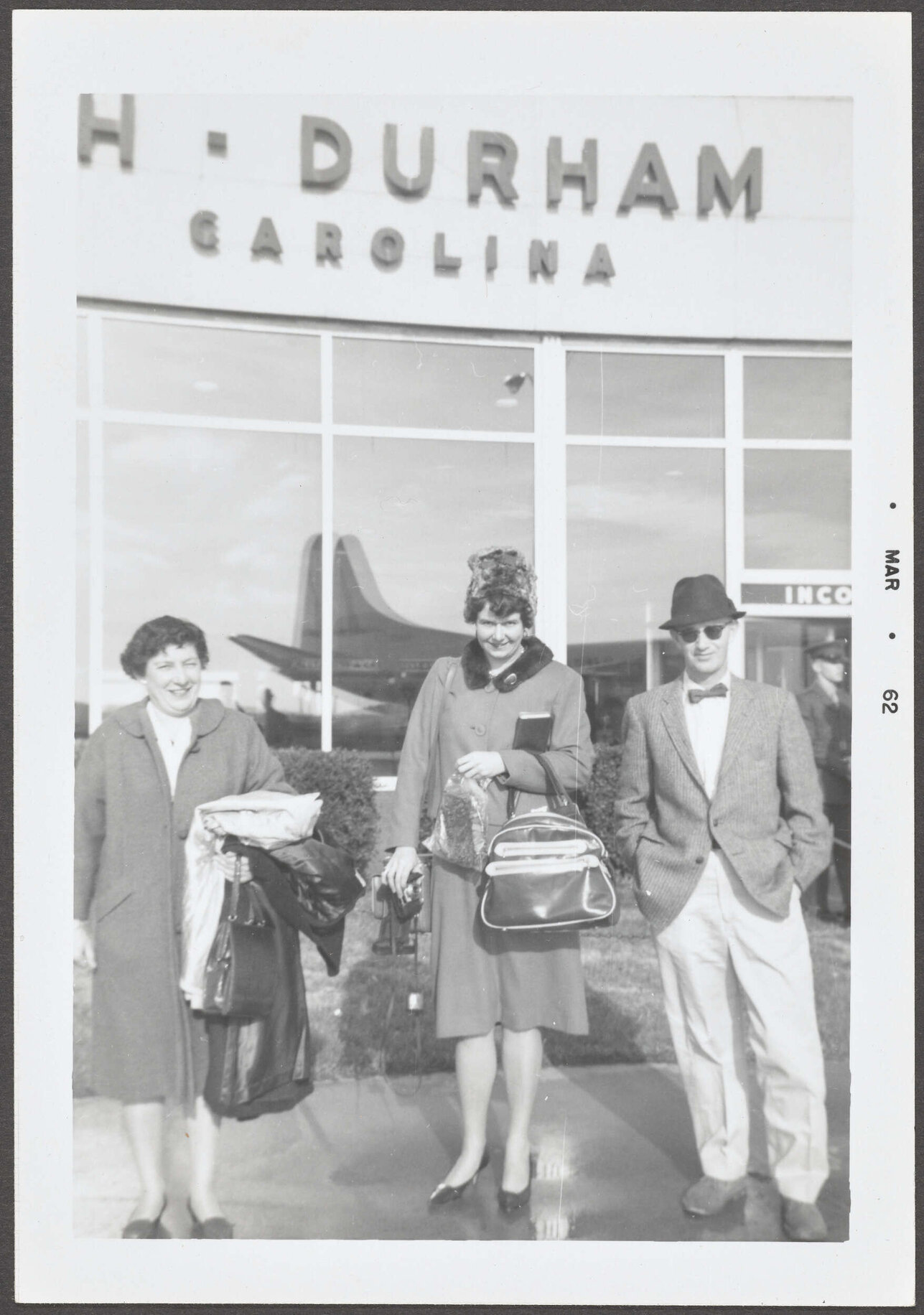 Brenda Slade with two others at Raleigh-Durham Airport, North Carolina