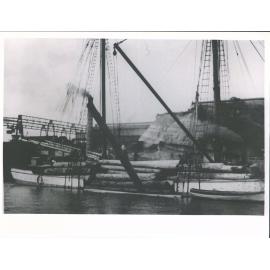 loaded down to deck level scow Ngahau unloading at Auckland Mills.'