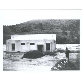 The Roaring Meg power station stands isolated by the unprecedented flood in the Kawarau River near Cromwell. Three feet of water