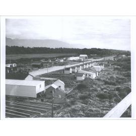 "Ministry of Works workmen's huts and yard at Haast Settlement, looking south"