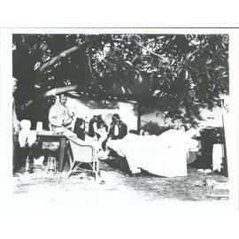 In a temporary dressing station Dr Gerald Patrick Fitzgerald sitting on table