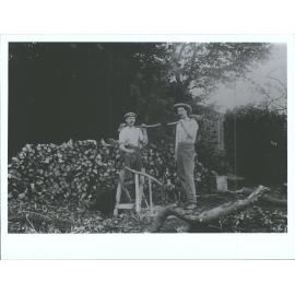 Two woodcutters and their dogs