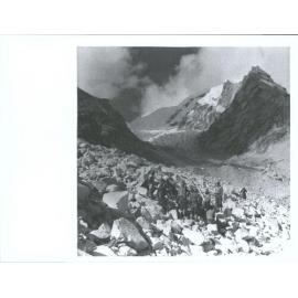 "Hard going on the journey back, Members of the Himalayan Expedition carrying Sir Edmund Hillary on a stretcher over rough bould