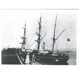 Antarctic Steamer Discovery coming alongside the wharf at Port Chalmers -showing  the Blue Ensign at half mast  'high"