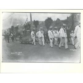 Boy in group in costume with collection box