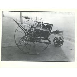 cultivator with seeder mounted on top.