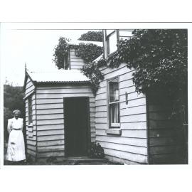 Miss Mitchell outside house